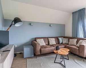 Gemtliches Wohnzimmer im Nieuwlanderweg 77, De Koog, Texel, mit moderner Einrichtung und Blick auf die Natur des Wattenmeeres.