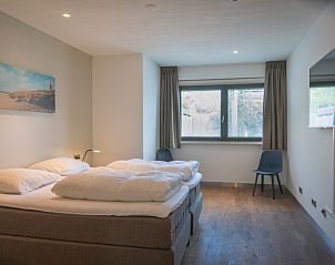 Bedroom with modern dcor in Orchismient 24, De Koog, Texel, featuring flat-screen TV.