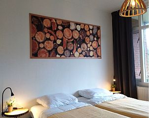 Attractive bedroom in 't Kerckeland - Apartment Kerckeland 82, De Koog, Texel, with comfortable beds and soothing decoration.