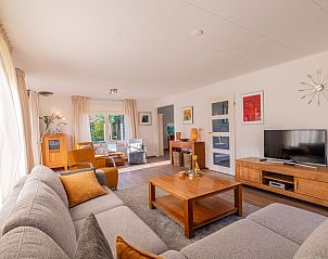 Bright living space in Holiday home Honeysuckle 61, De Koog, Texel with wooden furniture and lots of natural light.
