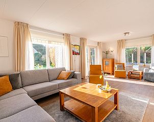 Sunny living room of Holiday home Honeysuckle 61 in De Koog, Texel overlooking the garden.
