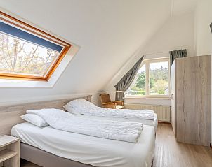 Attractive bedroom in Holiday home Honeysuckle 61, De Koog, Texel with skylight and view.