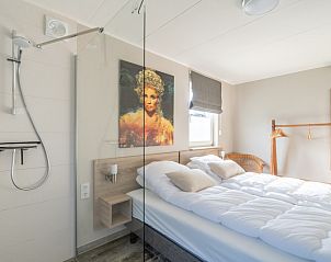 Bedroom in Holiday home Honeysuckle 67 De Koog Texel with modern bathroom and natural light on the Wadden Islands.