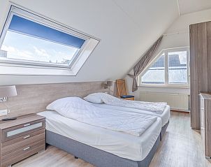 Spacious bedroom in Holiday home Kamperfoelie 49, De Koog, Texel, with skylight and comfortable beds.