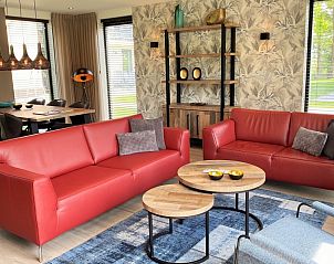 Stylish living room in 6 Pers.Landhuis de Luxe Eldorado Texel, De Koog, with red sofas.