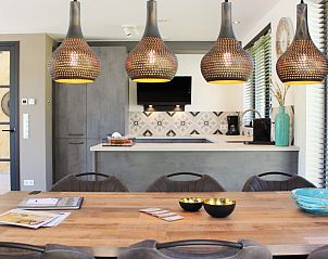 Dining area with hanging lamps in 6 Pers.Landhuis de Luxe Eldorado Texel, De Koog.