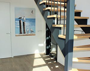 Modern staircase in 6 Pers.Landhuis de Luxe Eldorado Texel, De Koog, with art on the wall.