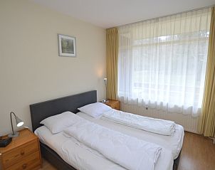 Comfortable bedroom in Apartment Kerckeland 24, De Koog, Texel with large window and serene ambience.