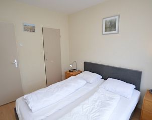 Bedroom in Apartment Kerckeland 24, De Koog, Texel with double bed and quiet decor.