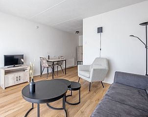 Dining area and living room in Two persons apartment large - first floor, De Koog, Texel for relaxed meals.