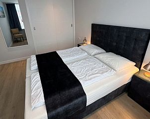 Luxury bedroom in Holiday home Duinzee Texel in De Koog with large double bed and modern interior.