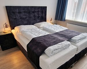 Bedroom in Holiday home Duinzee Texel in De Koog with elegant bed and lots of natural light.
