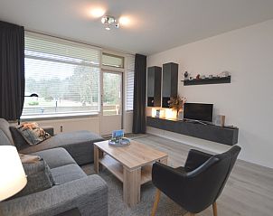 Spacious sitting room in Apartment Kerckeland 106, De Koog, Texel overlooking green surroundings.