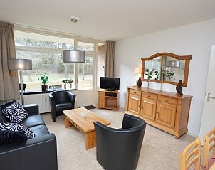 Gemtliches Wohnzimmer im Appartement Kerckeland 28, De Koog, Texel mit bequemer Sitzecke und Blick auf die Natur.