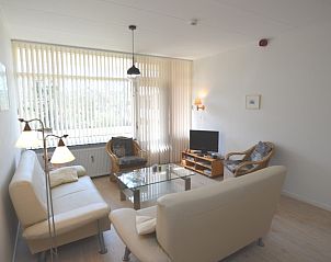 Bright living room with large windows in Apartment Kerckeland 80, De Koog, Texel, ideal for relaxation.