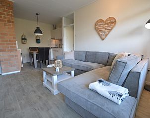 Open living room and dining area in Apartment Kerckeland 78, De Koog Texel, with access to the kitchen.