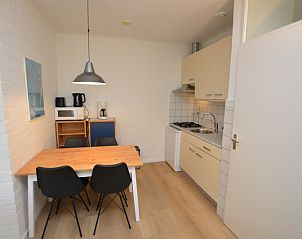 Compact kitchen in Apartment Kerckeland 126, De Koog, Texel, with dining table and modern appliances.