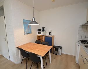 Dining area and kitchen in Apartment Kerckeland 126, De Koog, Texel, ideal for cozy meals.