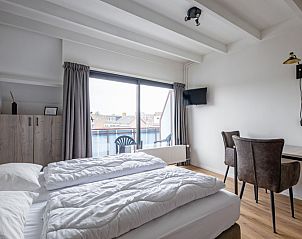 Spacious bedroom with balcony in Two person studio - second floor, De Koog, Texel for a relaxing stay.