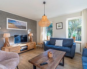 Cozy living room in Holiday Home Honeysuckle 57, De Koog, Texel with comfortable seating area and natural light.