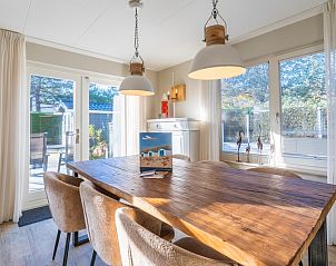 Stylish dining area in Holiday Home Honeysuckle 57, De Koog, Texel with garden views and plenty of natural light.