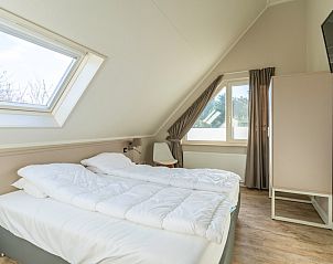 Bright bedroom with skylight in Holiday home Honeysuckle 57, De Koog, Texel offers comfort on the Wadden Islands.