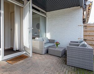 Private terrace of Motel Texel Apartment with bath (B), De Koog, Texel with stylish outdoor seating.