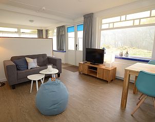 Cozy living room in Grand Hotel Opduin - Holiday home B, De Koog, Texel with comfortable seating area and views of nature.