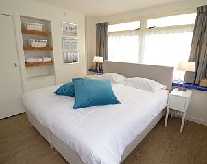 Luxury bedroom in Grand Hotel Opduin - Holiday home B, De Koog, Texel with large bed and atmospheric lighting.