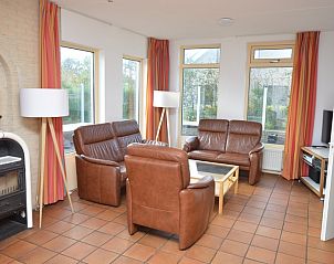 Bright sitting area in Holiday home Stappeland 199, De Koog, Texel, with modern furniture and a cozy wood stove.