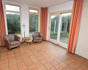 Spacious living space in Holiday home Stappeland 199, De Koog, Texel, with large windows and views of the garden.