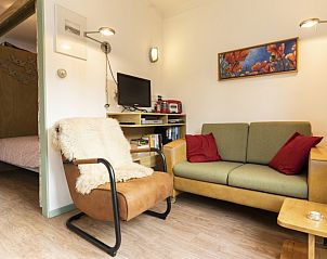 Cozy sitting area in Schanulleke, De Koog, Texel, vacation home with comfortable sofa and armchair.