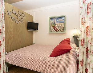 Attractive bedroom in Schanulleke, De Koog, Texel, vacation home with double bed and decorative elements.