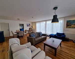 Ruime woonkamer in Bungalow Epelaan 13, De Koog, Texel met comfortabele zithoek en veel natuurlijk licht.