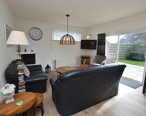 Cozy living room in Holiday home Stappeland 205, De Koog, Texel with comfortable seating area and access to the garden.