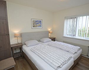 Comfortable bedroom in Holiday home Stappeland 205, De Koog, Texel with a large bed and peaceful ambiance.