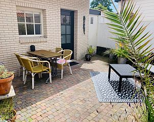 Outdoor area at Texel D vacation home, De Koog, Texel, with colorful mural and comfortable seating.