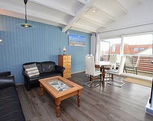 Spacious indoor area of Motel Texel - Apartment 315/1T, De Koog, Texel with dining area and terrace view.
