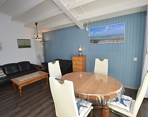 Cozy living room of Motel Texel - Apartment 315/1T, De Koog, Texel with inviting seating and beach theme.