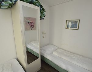 Cozy bedroom in Motel Texel - Apartment 315/1T, De Koog, Texel with a single bed and views of the island.
