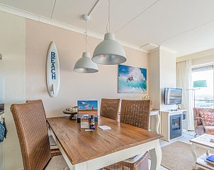 Dining area in Apartment Juliana 148 Island and Sea View, De Koog, Texel with wooden table and wicker chairs.