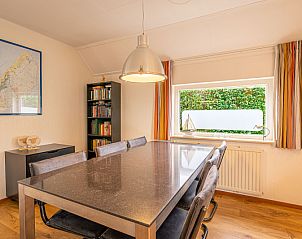 Dining room in Holiday home Honeysuckle 43 with sauna, De Koog, Texel, offers a cozy place for meals overlooking the garden.