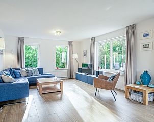 Spacious living space in Holiday home Kamperfoelie 37 De Koog Texel with large windows.