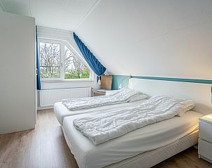 Cozy bedroom in Holiday home Kamperfoelie 37 De Koog Texel overlooking nature.