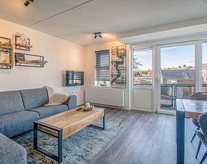 Spacious living room with balcony view in Apartment Zeedistel 20, De Koog, Texel, perfect for relaxation.