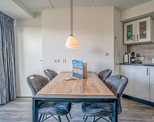 Cozy dining area in Apartment Zeedistel 20, De Koog, Texel with modern lighting and wooden table.