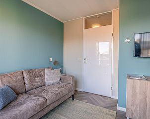 Modern furnished living room with TV in Apartment Zeedistel 24, De Koog, Texel.