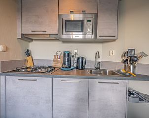Compact kitchen with modern appliances in Apartment Zeedistel 24, De Koog, Texel.