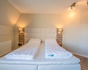 Comfortable double bed in bedroom of Apartment Zeedistel 24, De Koog, Texel.