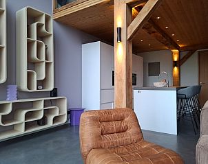 Villa 189 with Hot tub in De Koog, Texel features a bright living room with a fireplace and spacious windows.